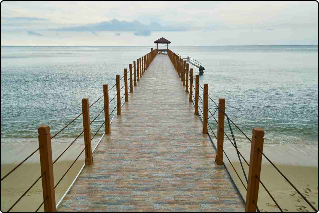 Wooden dock long extending over calm waters